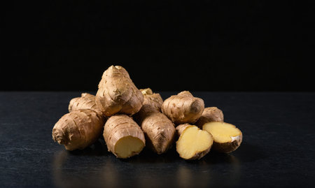 Fresh ginger root on a dark surfaceの素材