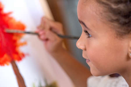 Close up of little girl painting on canvasの写真素材