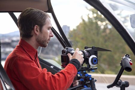 Videographer getting ready in helicopter