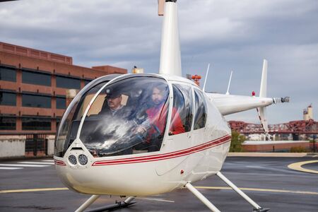 Pilot and videographer in a helicopter