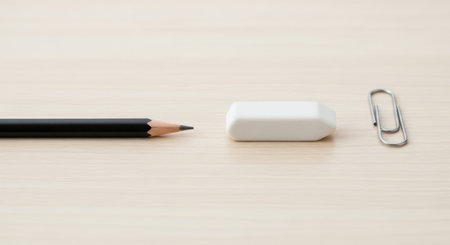 Pencil and eraser on wood table background - soft focus pointの素材