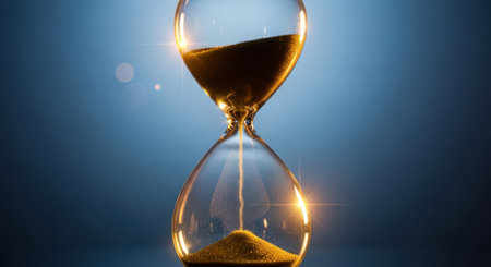 Hourglass on blue background. Concept of time passing. 3d renderingの素材