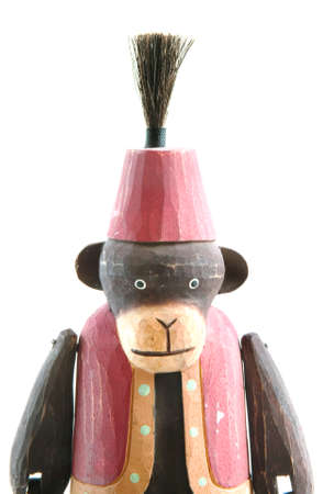 Wooden monkey in a vest and fez medium shot isolated on pure white.の写真素材