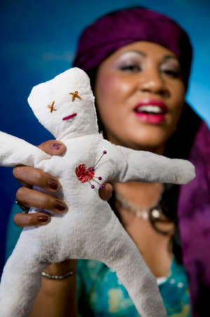 Gypsy fortune teller with an unfortunate voodoo doll.の写真素材