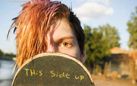 Teenage boy skateboarder with his board.の写真素材