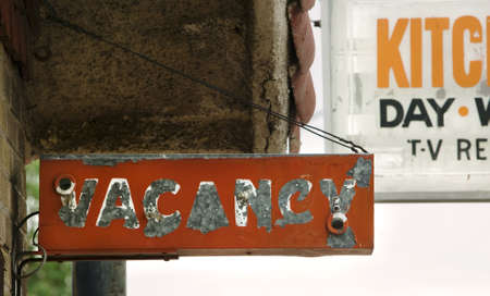 Decrepit and peeling orange motel vacancy sign.の写真素材