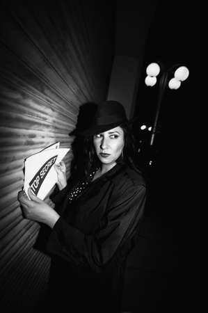 Spy with top secret documents in an industrial alley.の写真素材