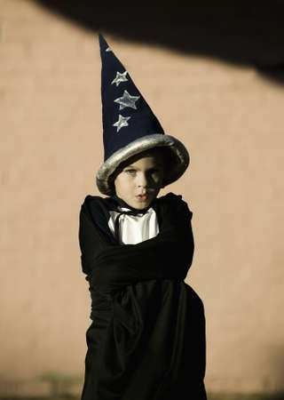 Young boy with a wizard and his arms crossedの写真素材