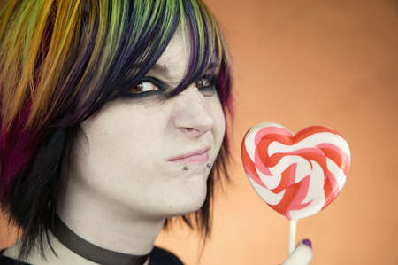 Alternative Girl with a Heart Lollipop Scrunches her Faceの写真素材