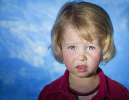 Little girl with blue eyes looks concerned