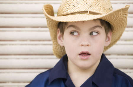 Young Boy in a Straw Cowboy Hat Looking to the Leftの写真素材