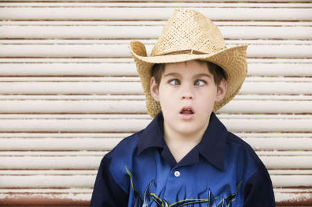 Young Boy in a Straw Cowboy hat Crosses His Eyesの写真素材