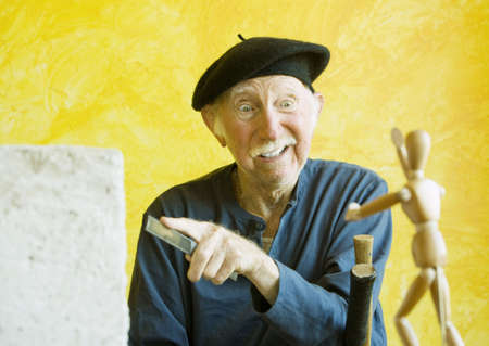 Crazy Artist ponders a wooden figure modelの写真素材