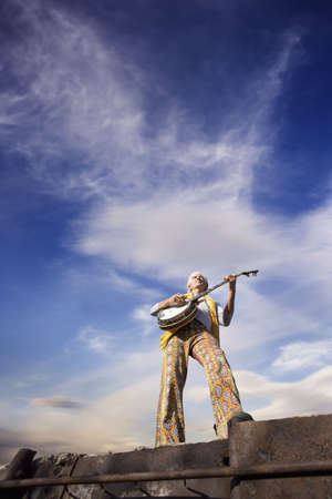 Banjo Player with groovy clothes against a wide skyの写真素材