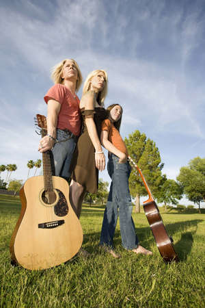Three family members with two guitarsの写真素材