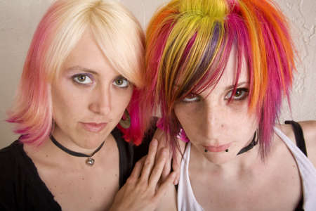 Two hip girls with brightly colored hairの写真素材