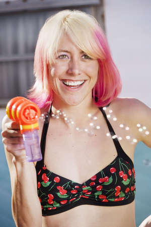 Woman in bikini with a bubble gunの写真素材
