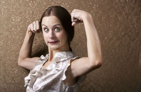 Pretty Young Woman Posing with Flexed Biceps