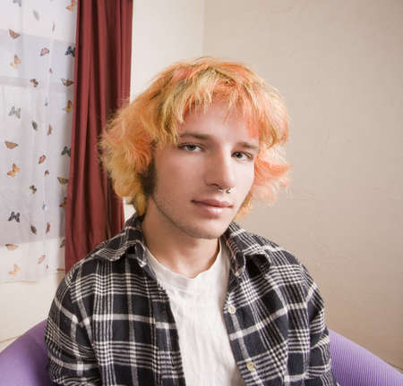 Closeup of a Young man with Bright Hair in a Bare Roomの写真素材