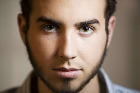 Closeup Shot of Young Man with Beard and Brown Eyesの写真素材