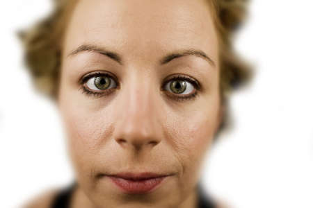 Extreme closeup of a young woman in front of white backgroundの写真素材