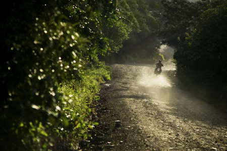Motorcycle on a dirt road at dusk in Santa Elena Costa Ricaの写真素材