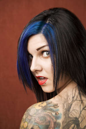Pretty young woman with many tattoos の写真素材