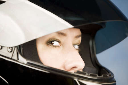 Hispanic woman wearing a black motrcycle helmet 
