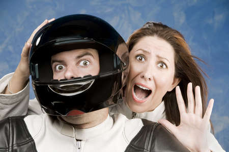 Man and fearful woman on a motorcycle in studio