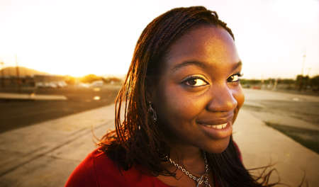 Pretty African American woman in an urban setting at sundown