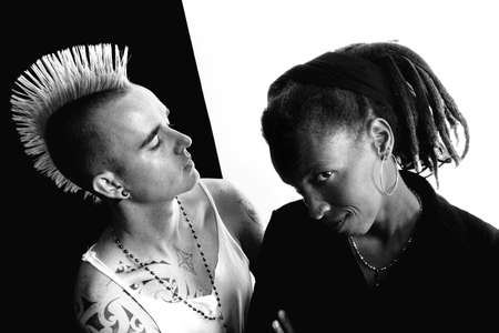 Portrait of white man with mohawk and black woman with dreadlocksの写真素材