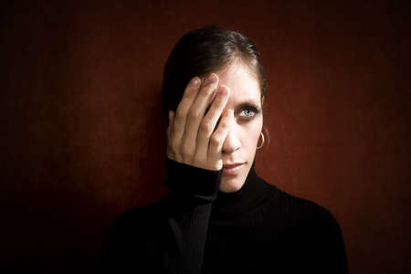 Pretty Woman a Black Turtleneck Covering her Eye