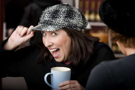 Pretty Hispanic woman with coffee and a big smileの写真素材