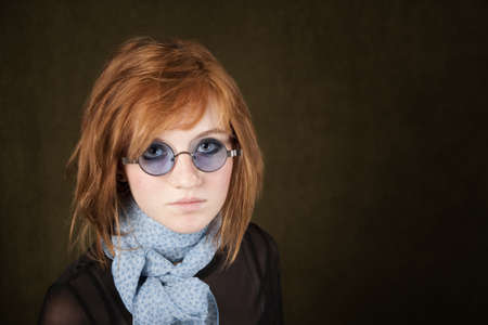 Pretty teenage girl with round blue sunglasses