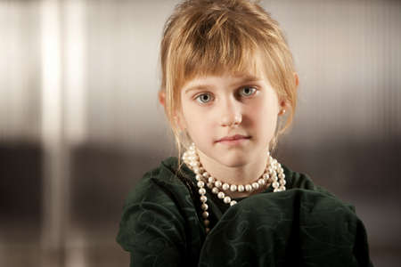 Cute young girl with big eyes in dress-up clothes