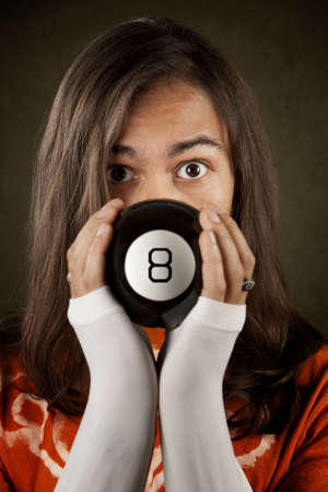 Man looking at the prediction on a magic toy ballの写真素材