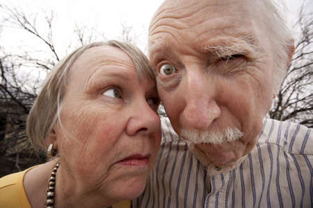 Closeup portrait of crazy elderly couple outdoorsの写真素材