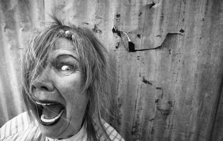 Senior homeless woman with too much makeup screamingの写真素材