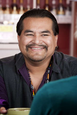 Handsome Native American man with friend in a restaurantの写真素材