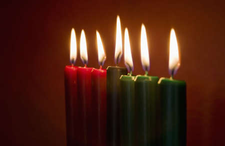Seven Kwanzaa candles with flames lit on neutral backgroundの写真素材