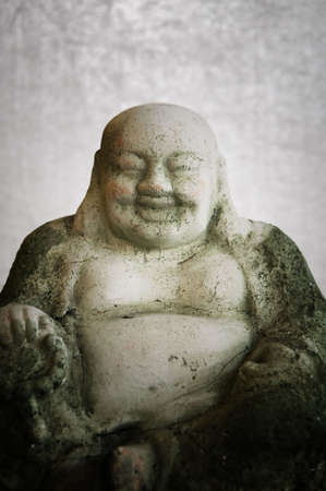 Concrete Buddha Statue on a mottled silver backgroundの写真素材