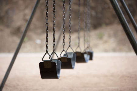 Old style playground swings with chains and rubber seatsの写真素材
