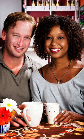 Caucasian man and African American woman in coffee houseの写真素材