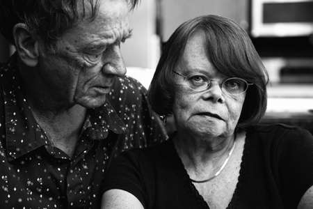Worried Senior Couple at Home in Modern  Kitchenの写真素材