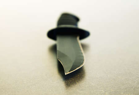 Tip of sharp knife blade on tabletopの写真素材