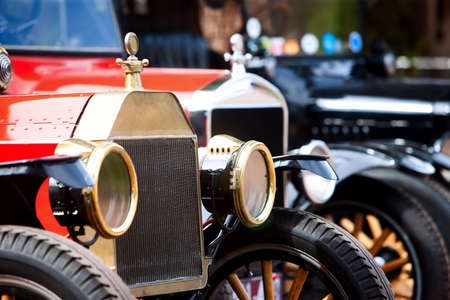 Headlights on several lined up vintage cars