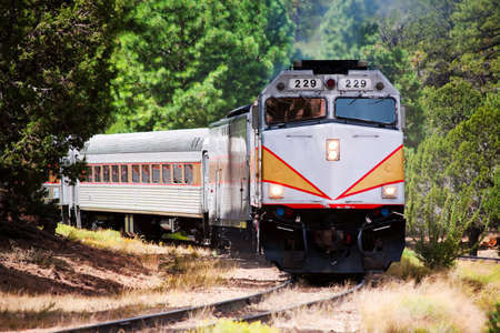 Vintage tourist train engine on curved trackの写真素材