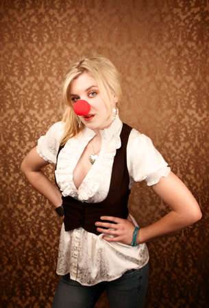 Pretty blonde girl with large red clown noseの写真素材