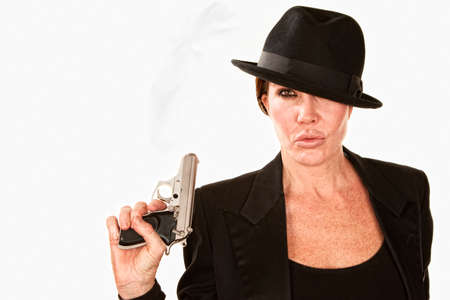 Woman in a fedora with small smoking gunの写真素材