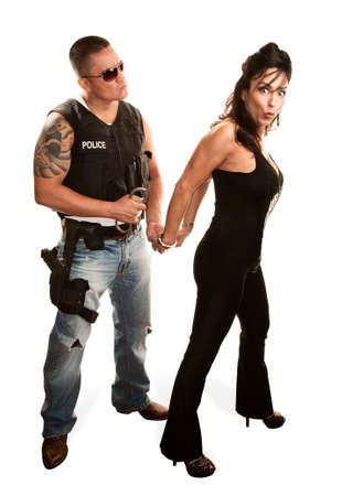 Macho policeman arresting pretty Latina womanの写真素材